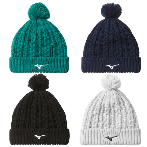 Four knitted winter hats are arranged in a square pattern. Each hat features a pom-pom on top and has a logo on the front. The colors include teal black navy and white.