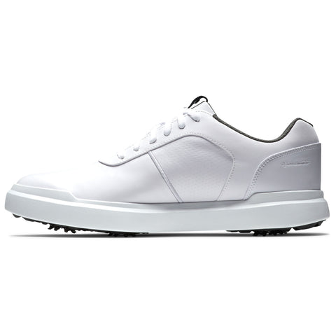 A white golf shoe sits on a surface showcasing its sleek design and textured side panels featuring small grip spikes on the sole for traction during play.