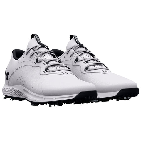 White golf shoes are positioned side by side displaying a sleek design including a textured upper and spiked outsole suitable for traction on grass surfaces.