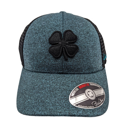 A teal and black baseball cap featuring a four-leaf clover logo is displayed prominently against a plain background with a tag indicating it has specialized memory fit technology.