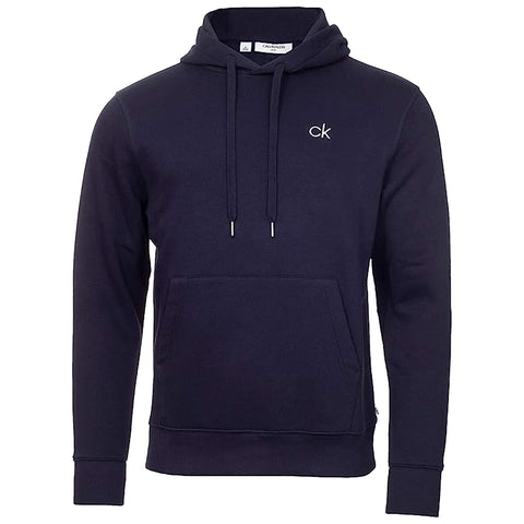 A navy blue hoodie with a front pocket and drawstrings hangs upright showcasing a small embroidered logo on the chest the fabric appears soft and casual suitable for relaxed wear.