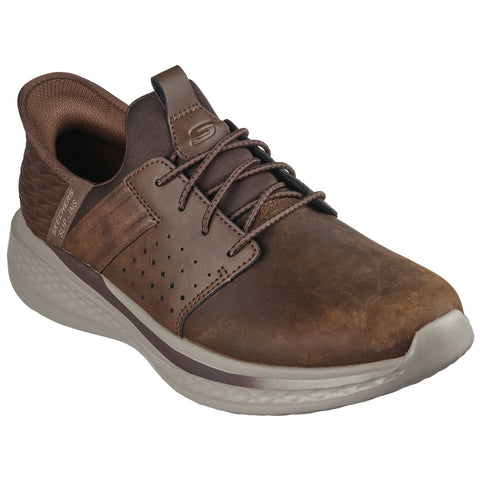 A brown leather sneaker features a textured design and perforations on the side with laces on the top resting against a white background suggesting casual and comfortable wear.