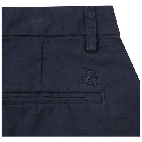 A navy fabric with a smooth texture features a stitched pocket and a logo embroidered in the bottom right corner, indicating a garment like pants or shorts.