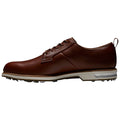 A brown leather golf shoe is displayed, featuring a smooth upper and a low profile design with a rubber sole designed for traction on a golf course.