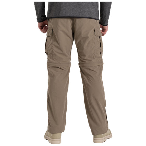 Beige cargo pants are worn by a person facing away with hands at their sides in a neutral setting, highlighted by multiple pockets and a relaxed fit suitable for outdoor activities.