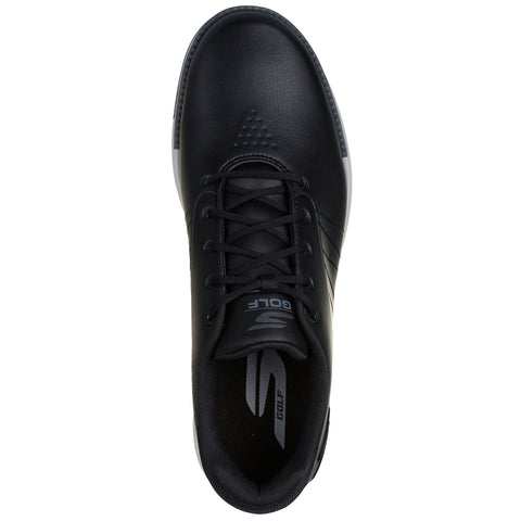 A black golf shoe is positioned flat displaying its top view with laces and a logo visible its sleek design suggests athletic purpose suitable for golfing activities in outdoor settings.