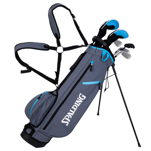 A gray golf bag with a blue zipper and branding contains golf clubs, standing on three legs. The bag features a shoulder strap for carrying during outdoor use.