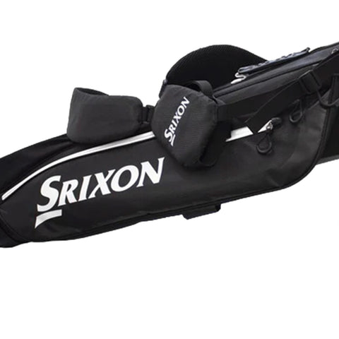 A black golf bag with white accents holds various golf clubs and features a padded strap for carrying in an outdoor golfing environment. The brand logo "Srixon" is prominently displayed.