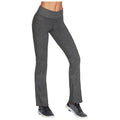 Leggings are being worn by a person standing on one leg showcasing their athletic appearance with a fitted high waistband and a sleek, dark gray material in a neutral background.