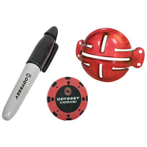 A black and silver pen rests beside a red golf ball marker and a red putting aid both labeled with the brand Odyssey in a simple display setting.