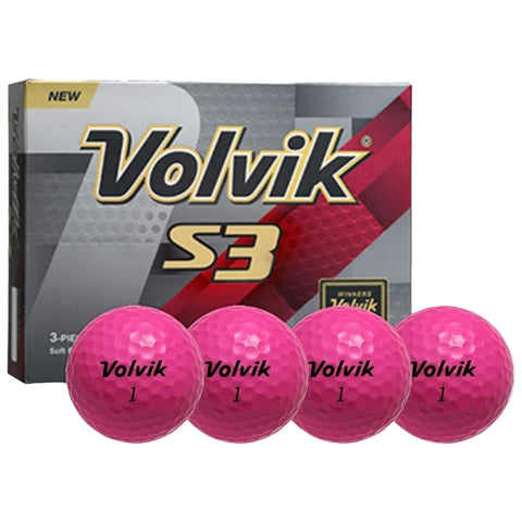 Four pink golf balls labeled Volvik 1 are displayed in a line in front of a partially visible box labeled Volvik S3 indicating it is a new three-piece golf ball set.