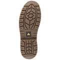 A brown rubber shoe sole is displayed showing deep treads designed for traction and stability indicating its purpose for outdoor or work environments the marking reads OIL RESISTANT