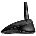 A black golf club head is shown facing left with sleek contours and a shiny surface reflecting light surrounded by a white background highlighting its design details.