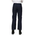 Navy cargo pants are worn by a person standing with their back to the viewer in a neutral setting, showcasing pockets and a relaxed fit, paired with black boots.