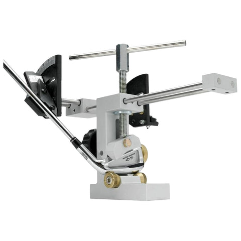 A white and metallic golf club fitting tool is positioned upright with adjustable components engaged in alignment and measurement actions set against a neutral background.