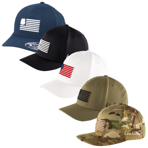 Five baseball caps are displayed in a row featuring various colors like navy blue black white olive green and camo each adorned with horizontal stripe designs representing a flag and the text Live Lucky on the camo cap