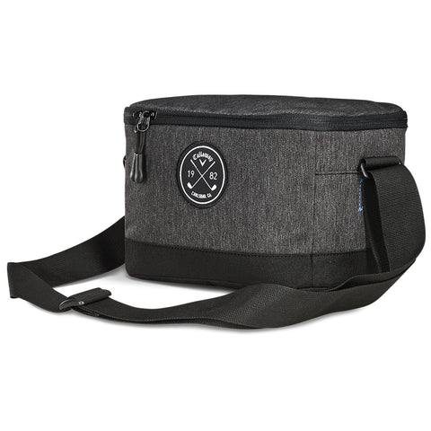 A black and gray insulated cooler bag features a top zipper and an adjustable strap with a round logo patch displaying the year 1982 on the front.