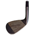 A golf club head is tilted at an angle showcasing its flat striking surface and textured grooves reflecting use against a plain background highlighting its metallic finish.