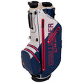 A golf bag with a stand and adjustable straps is positioned upright. It features a two-tone green and gray design and includes the text CHALLENGER ULTRA DRY prominently displayed.