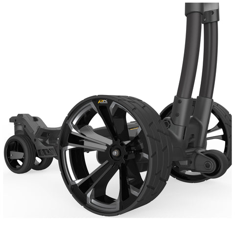 A close-up of a modern two-wheeled stroller frame showcases sleek black wheels with a shiny finish while smaller wheels assist in maneuverability in a clean white background.