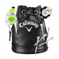 A black leather pouch with a drawstring contains golf accessories including a green and silver divot repair tool a golf tee marker and several white golf tees decorated with a logo.