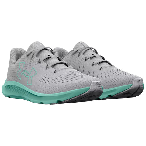 Light gray athletic shoes with a textured surface and a mint green sole are positioned to show their shape and design against a plain white background.