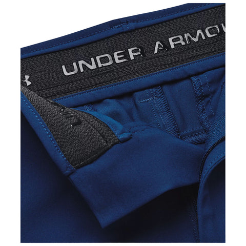 A pair of blue athletic shorts is displayed with a focus on the waistband featuring the text UNDER ARMOUR the shorts are made of soft fabric with neat stitching and elastic material