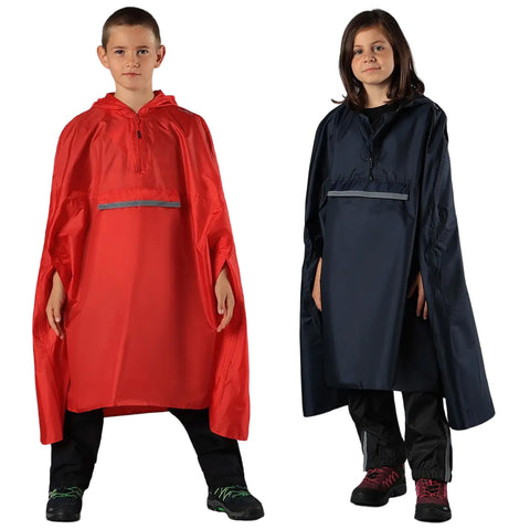 Two children stand side by side wearing large ponchos one in bright red and the other in dark navy both display relaxed expressions in a neutral setting