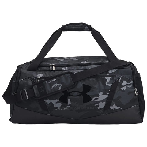 A large black and gray camouflage duffel bag with two handles and an adjustable shoulder strap sits flat against a surface displaying a prominent Under Armour logo on the side.