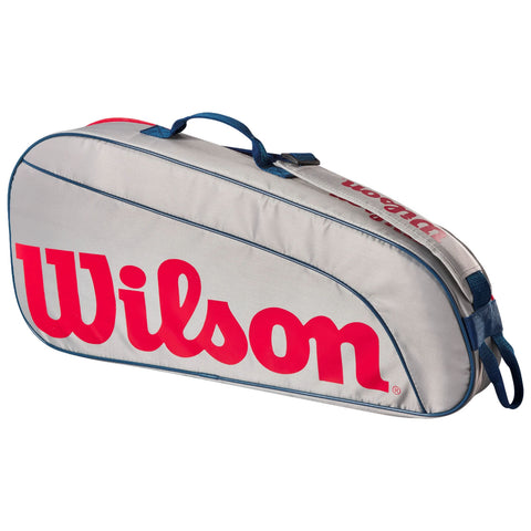 A gray tennis bag with red Wilson branding is positioned diagonally on a flat surface featuring a blue handle and a zipper along the top for easy access to contents.