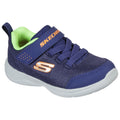 A navy blue athletic shoe with a mesh upper features a bright green interior and a Velcro strap embossed with the brand name Skechers and an orange logo provides comfort for active wear.