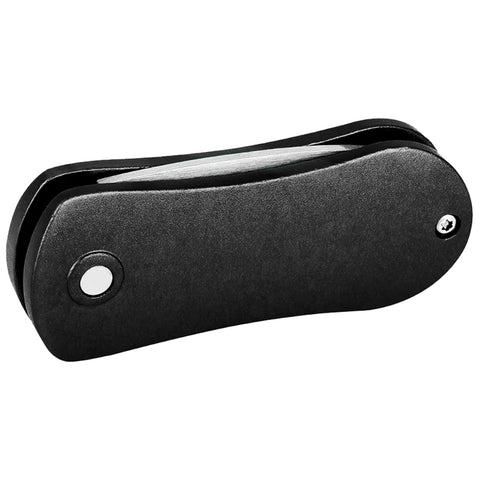 A black folding knife is closed and resting flat. Its rounded edges and smooth surface suggest a sleek design, suitable for carrying in a pocket or bag.