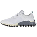 A white athletic shoe with a textured upper and gray sole featuring black circular cushioning elements sits on a plain background showcasing its modern design and sporty aesthetic.