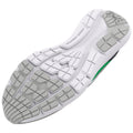 A shoe sole is displayed featuring a white base with gray traction patterns and a green accent. The sole is shown from a top-down perspective emphasizing the design and grip elements.