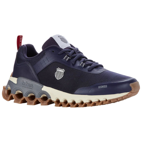 A navy and gray athletic sneaker features a textured upper, a K-Swiss logo, and a chunky rubber outsole with pronounced grips, suitable for sports or casual wear.