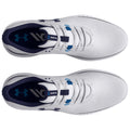 White athletic shoes with a navy interior and blue detailing rest on a flat surface featuring laces and a branded logo. The shoes are designed for sport or casual wear.