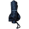 A black umbrella is tightly rolled and secured with a strap labeled EYLEVEL resting on a circular base with a string for easy carrying in a neutral backdrop.