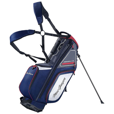 A golf bag stands upright with a sturdy center support and adjustable shoulder straps for carrying golf clubs. It's designed in navy blue with red and white accents, featuring a zippered compartment.