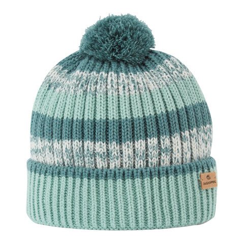 A knitted beanie with teal and mint stripes sits upright featuring a pompom on top and a folded cuff showcasing a small brand label on the side