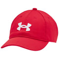 A red baseball cap with a white Under Armour logo is positioned at an angle showcasing its curved brim and structured design in a neutral background.