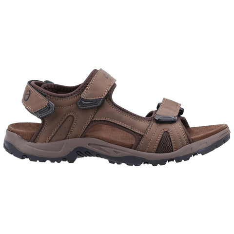 Brown sandal with adjustable straps rests on a white background showcasing a cushioned footbed and a textured rubber sole designed for comfort and durability in casual outdoor settings.