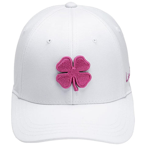 A white cap adorned with a pink four-leaf clover emblem is displayed prominently against a neutral background. The cap features a structured fit and textured fabric.