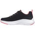 A black athletic shoe with a textured upper and pink accents sits flat on a surface showcasing its sleek design and prominent white midsole emphasizing comfort and support.