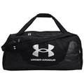 Black duffel bag with a large white Under Armour logo rests on a flat surface featuring a sturdy shoulder strap and dual handles for easy carrying.