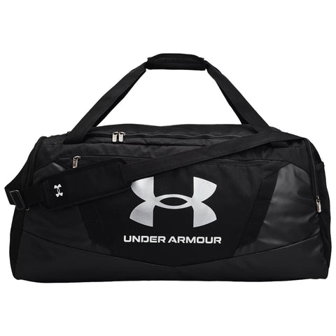 Black duffel bag with a large white Under Armour logo rests on a flat surface featuring a sturdy shoulder strap and dual handles for easy carrying.