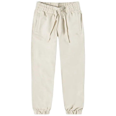 Beige jogger pants with an elastic waistband are positioned upright displaying two side pockets and elasticated cuffs at the ankles against a plain white background.