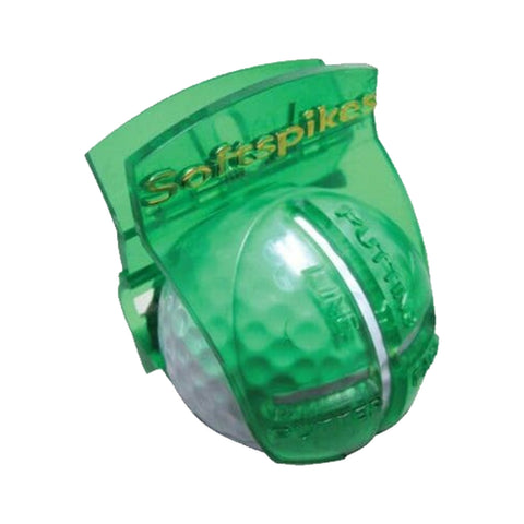 A green golf putting aid holds a golf ball in a semi-transparent shell while aligning it for a putt on a flat surface like a golf course or practice area.