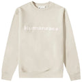 A light-colored sweatshirt with the word Humanrace prominently displayed across the chest in a bold font is centered against a plain background suggesting a casual clothing item for comfortable wear.