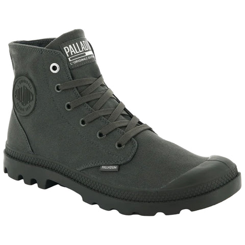 A green canvas boot features a rubber sole with a textured grip laces are threaded through eyelets and branding is visible on the side and tongue in a casual setting