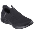 A black slip-on shoe is displayed resting on a flat surface showcasing its knitted upper texture and a curved sole designed for comfort and flexibility.